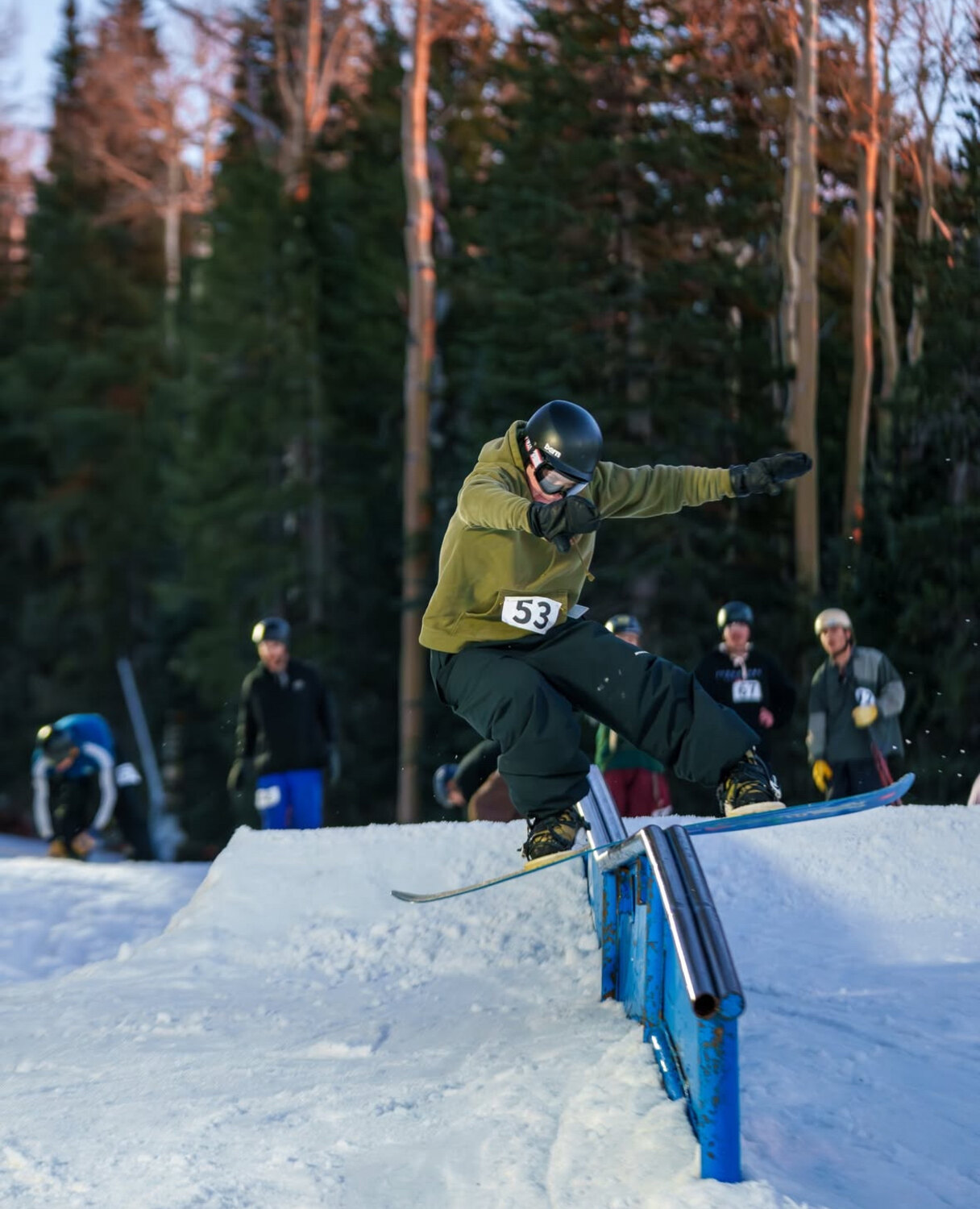 Logan Ecalono snowboarding a rail in the terrain park